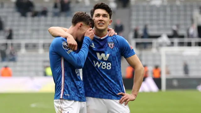 Chris Rigg and Luke O'Nien embrace after Sunderland's win at Newcastle
