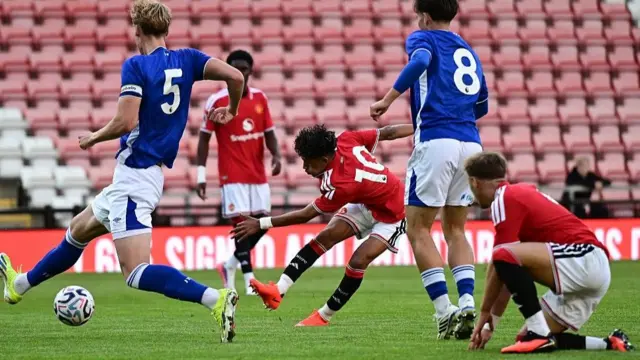 Manchester United forward JJ Gabriel gets in a shot in against Ipswich