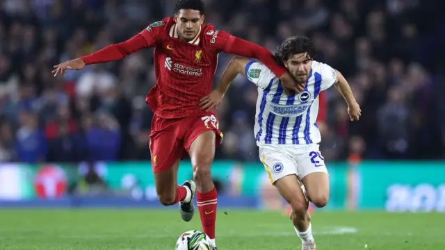 Liverpool and Brighton players contest in the League Cup