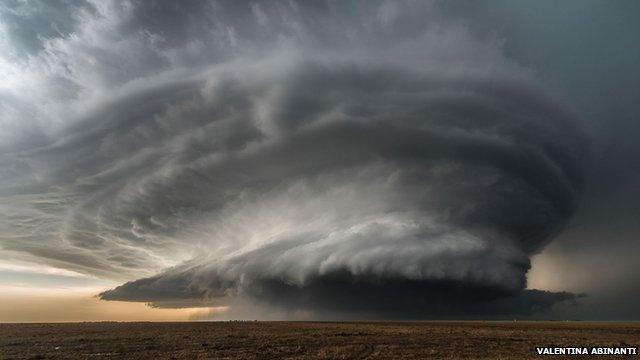 Huge circular storm producing cloud over a field