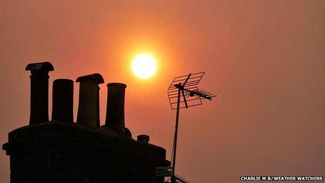 Red sun above rooftops