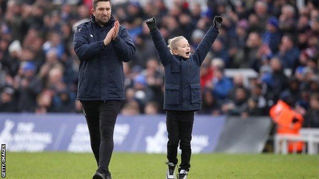 Graeme Lee and his son Grayson celebrating on the pitch after Hartlepool knocked Championship side Blackpool out of the FA Cup