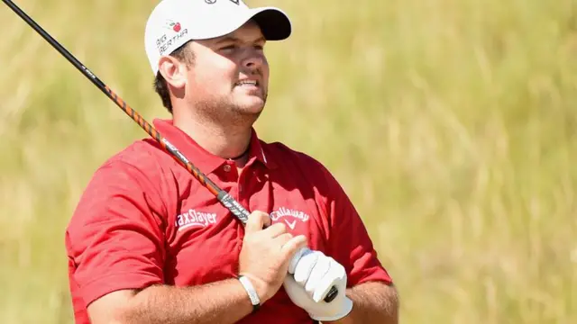 Patrick Reed looks on