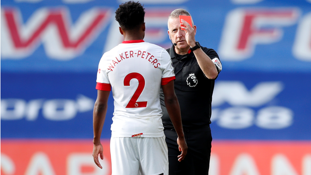 Kyle Walker-Peters is shown a red card by referee Jonathan Moss