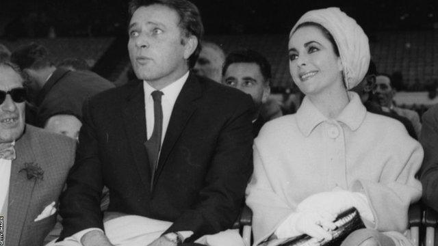 Richard Burton and Elizabeth Taylor have front row seats for Ali's fight with Henry Cooper at Wembley Stadium in 1963