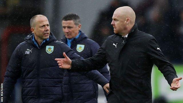 Burnley boss Sean Dyche (right) walks to the dressing room after their defeat by Leicester