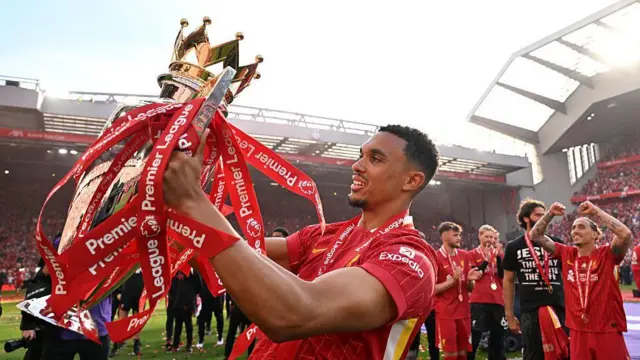 Trent Alexander-Arnold of Liverpool celebrates with the Premier League trophy