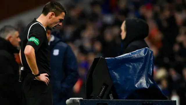 Referee checks pitchside monitor