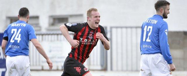 A delighted Jordan Owens runs away in celebration after scoring against Glenavon