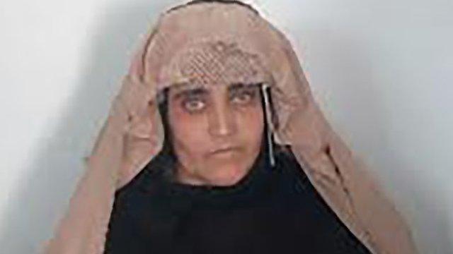 In this handout photograph released by Pakistan"s Federal Investigation Agency (FIA) on October 26, 2016, Afghan Sharbat Gula, the "Afghan Girl" who appeared on the cover of a 1985 edition of National Geographic magazine, waits ahead of a court hearing in Peshawar