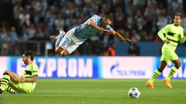 Malmo star Nikola Djurdjic is sent sprawling by Charlie Mulgrew