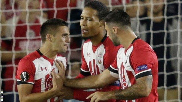 Dusan Tadic (left) argues with Charlie Austin (right) about who takes Southampton's penalty