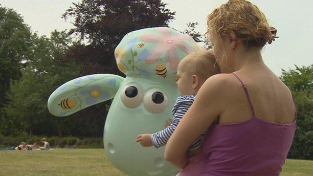 Mother and child with Shaun the Sheep sculpture