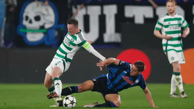 Callum McGregor battles for possession