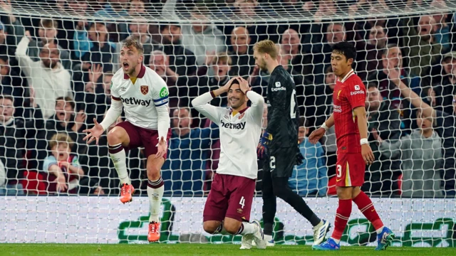 West Ham's players react during the EFL Cup tie with Liverpool