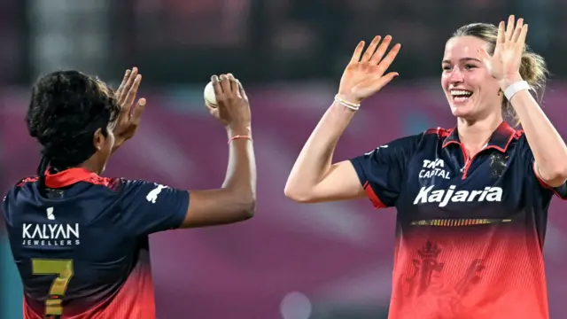 Lauren Bell celebrates a wicket in a WPL match