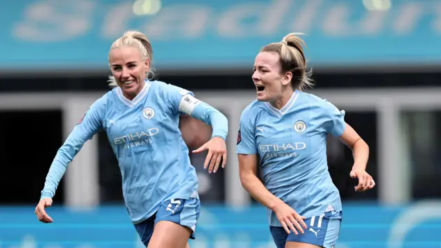 Alex Greenwood and Lauren Hemp in action for Manchester City