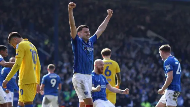 Portsmouth's Regan Poole and Connor Ogilvie celebrate after their victory against Leeds United after the full-time whistle is blown