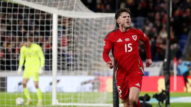 Liam Cullen celebrates scoring for Wales