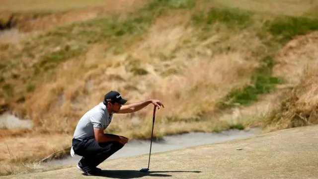 Jason Day lines up a putt