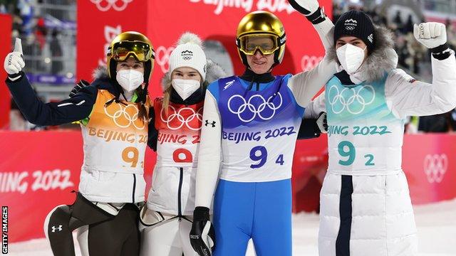 Slovenia celebrate winning gold in the inaugural Olympic ski jumping mixed team event