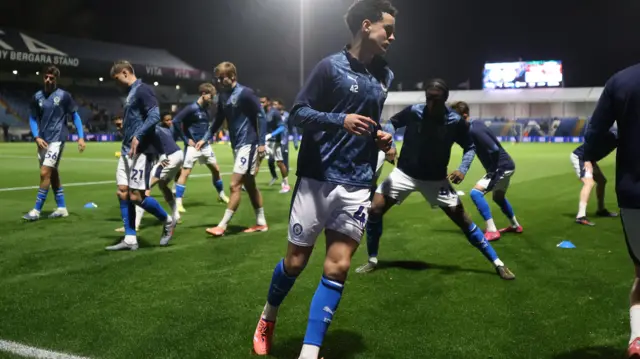 Arian Allen warms up for Stockport County last season before their EFL Trophy game against Wigan Athletic