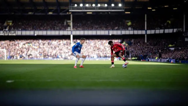 Patrick Dorgu of Manchester United in action with Jesper Lindstrom of Everton