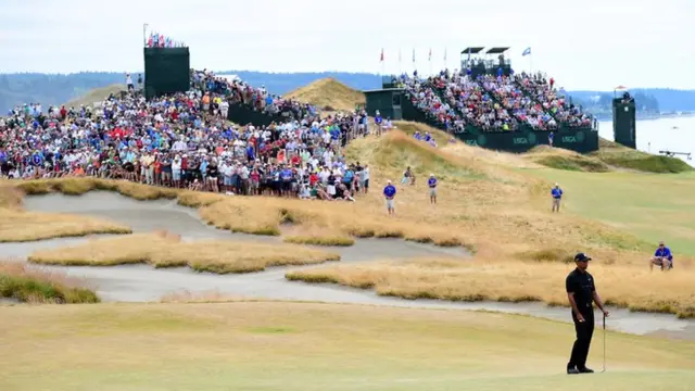 Tiger Woods stands in front of crowds