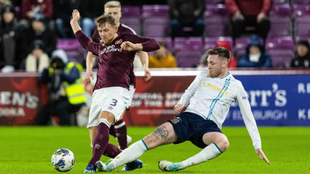 Stephen Kingsley and Jordan McGhee battle for possession