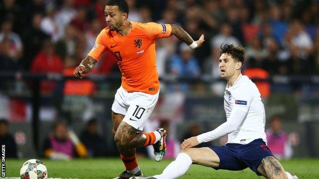 Memphis Depay tackles John Stones