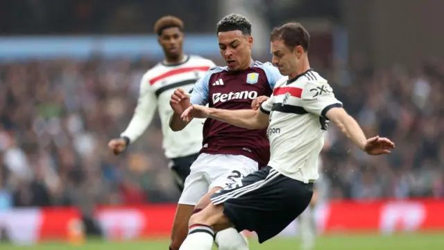 Manchester United defender Jonny Evans tackles Morgan Rogers of Aston Villa