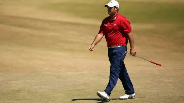 Patrick Reed walks across the green