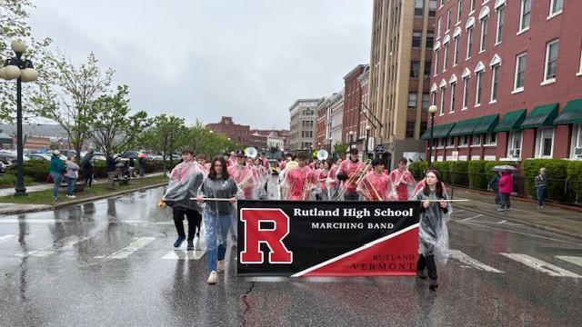 An image of a school band marching through the streets.