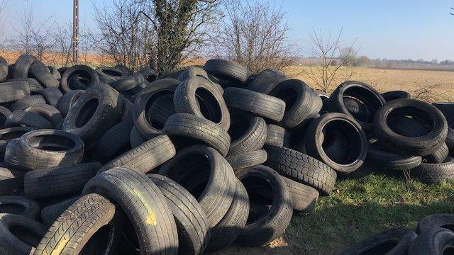 Huge pile of tyres dumped on land