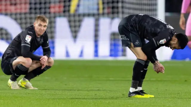 Swansea City players look dejected after their defeat at Watford