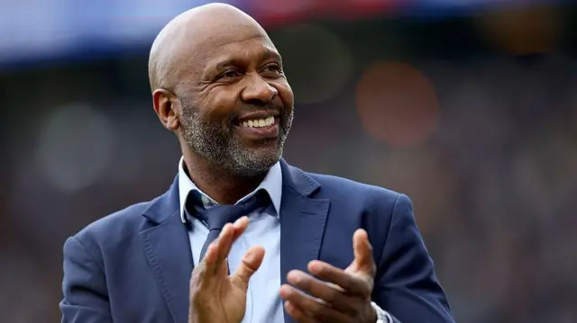 Former Leeds United player Lucas Radebe applauds the fans at half time