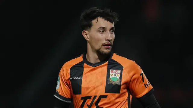 Ryan Galvin playing for Barnet in their orange and black kit