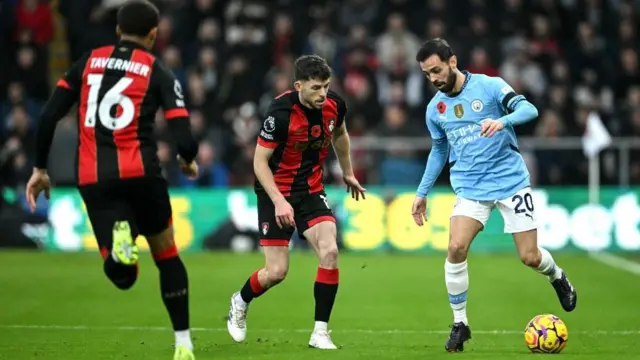 Bernardro Silva and Ryan Christie compete for the ball
