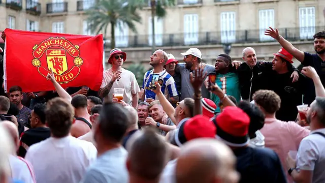 A large group of Manchester United fans gather