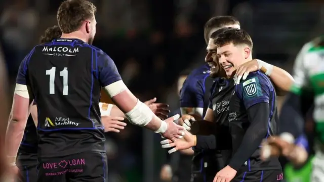 Glasgow Warriors players celebrate together