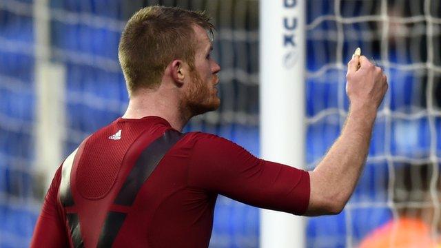 Chris Brunt holds up object