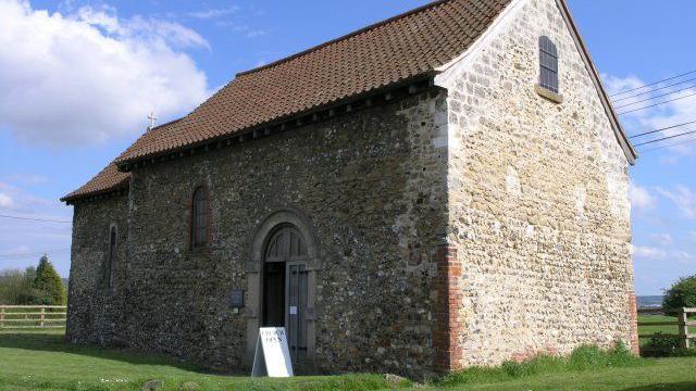 A small grey stone church