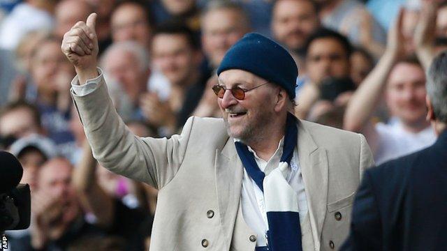 Chas of Chas and Dave fame responds after being introduced to the crowd at half-time