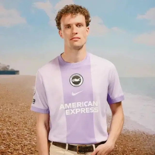 Mats Wieffer models the Brighton away kit which has two light purple stripes and a central dark purple with the Brighton badge, Nike logo and American Express sponsor lettering