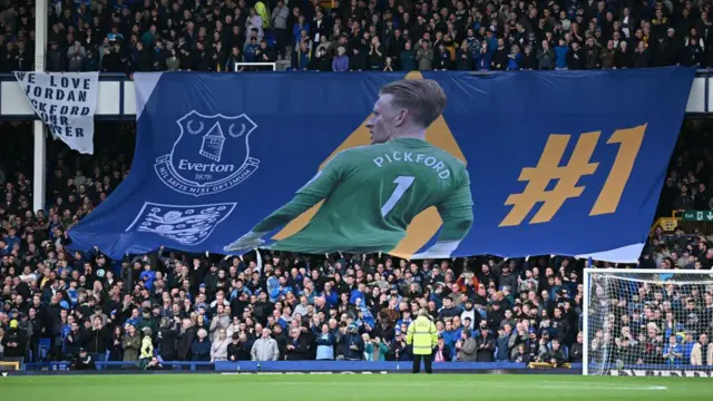 Everton fans hold a giant banner of goalkeeper Jordan Pickford during the Premier League match between Everton and Newcastle at Goodison Park