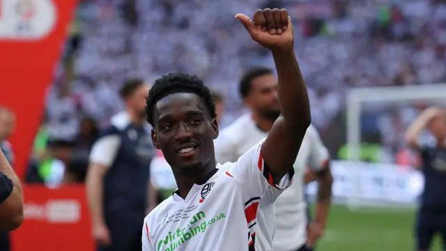 Amario Cozier-Dubbery putting his thumb up to the crowd after Bolton earn promotion with a win over Stockport at Wembley
