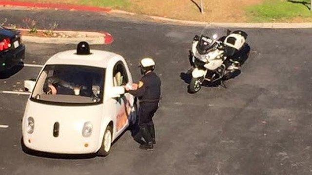 Police officer talking to person in self-drive car