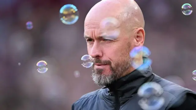 Erik ten Hag looks on surrounded by bubbles