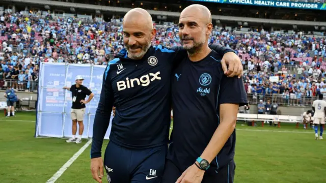 Enzo Maresca puts his arm around Pep Guardiola