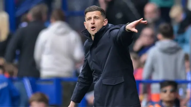Portsmouth boss John Mousinho gesticulates from the touchline